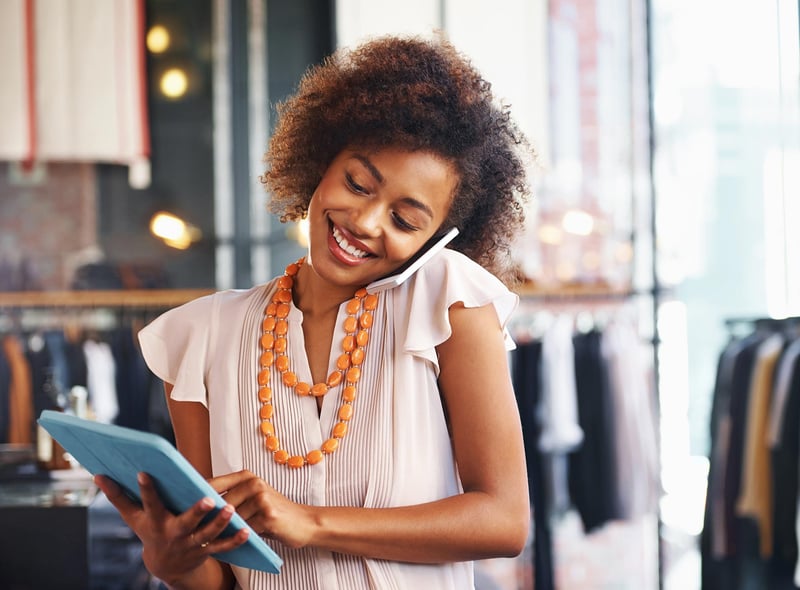 woman-holding-tablet-and-talking-on-mobile-phone.jpg