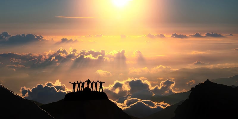 group-of-people-silhouette-on-mountain-clouds-sunset.jpg